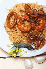 Image showing Italian seafood spaghetti pasta on red tomato sauce 