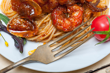 Image showing Italian seafood spaghetti pasta on red tomato sauce 