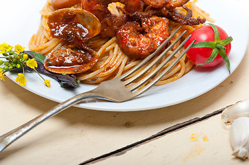 Image showing Italian seafood spaghetti pasta on red tomato sauce 