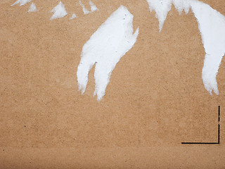 Image showing Brown corrugated cardboard background with ripped label