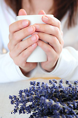 Image showing Hands holding a cup