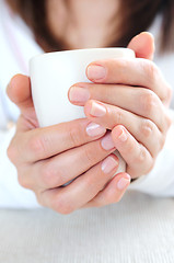 Image showing Hands holding a cup