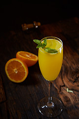 Image showing Orange cocktail on rustic wooden table