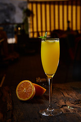 Image showing Orange cocktail on rustic wooden table