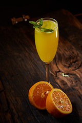 Image showing Orange cocktail on rustic wooden table