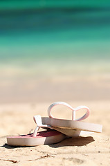 Image showing Flipflops on a sandy beach