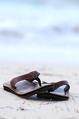 Image showing Flipflops on a sandy beach