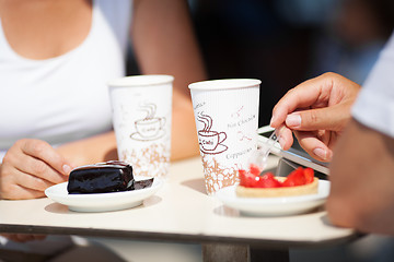 Image showing Couple enjoying coffee and cake at a cafeteria