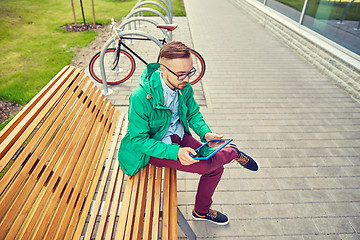 Image showing happy young hipster man with tablet pc and bike