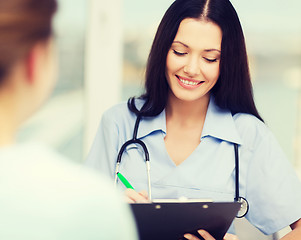 Image showing smiling doctor or nurse with patient