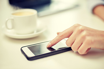 Image showing close up of woman hand with smartphone and coffee