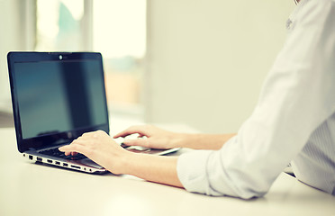 Image showing close up of woman typing on laptop at office