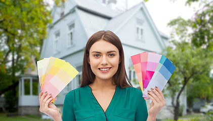 Image showing smiling young woman with color swatches