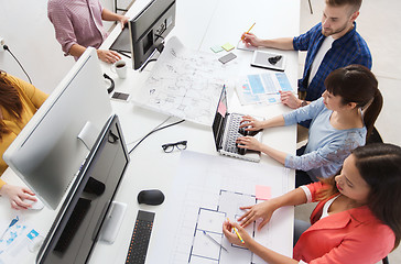 Image showing creative team with computers, blueprint at office