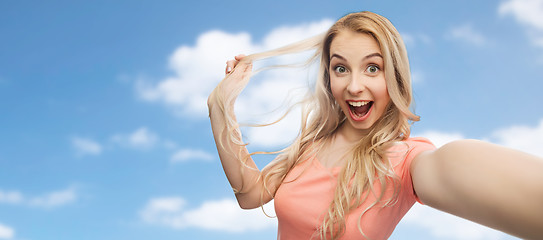 Image showing smiling young woman taking selfie