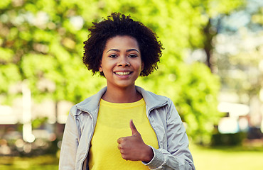 Image showing happy african american young woman in summer park