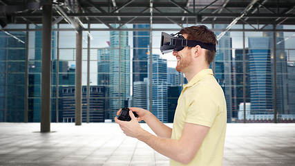 Image showing happy man in virtual reality headset with gamepad