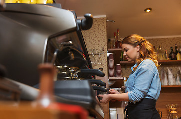 Image showing barista woman making coffee by machine at cafe