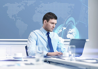 Image showing businessman with laptop working in office