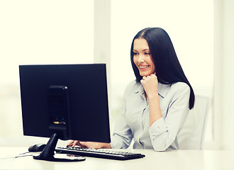 Image showing smiling businesswoman or student with computer