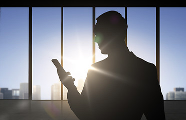 Image showing silhouette of businessman with smartphone