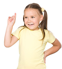 Image showing Cute little girl is pointing up