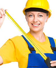 Image showing Young construction worker with tape measure