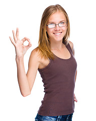 Image showing Young teen girl is showing OK sign