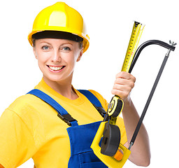 Image showing Young construction worker with hacksaw