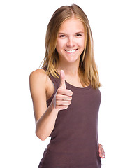 Image showing Woman is showing thumb up gesture