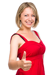 Image showing Woman is showing thumb up gesture