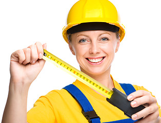 Image showing Young construction worker with tape measure