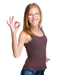 Image showing Young teen girl is showing OK sign