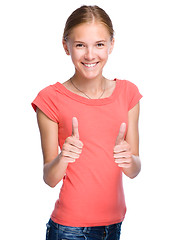 Image showing Young girl is showing thumb up gesture