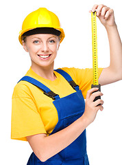 Image showing Young construction worker with tape measure