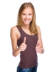 Image showing Young girl is showing thumb up gesture