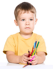 Image showing Little boy is holding color pencils