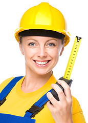 Image showing Young construction worker with tape measure
