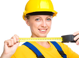 Image showing Young construction worker with tape measure