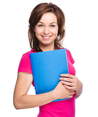 Image showing Young student girl is holding exercise book