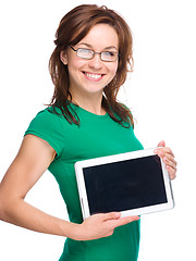 Image showing Young cheerful woman is showing blank tablet