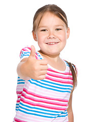 Image showing Little girl is showing thumb up gesture