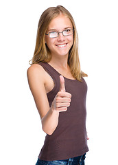 Image showing Young teen girl is showing thumb up gesture