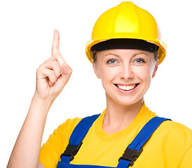 Image showing Young construction worker pointing up