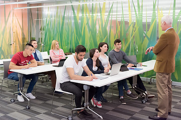 Image showing teacher with a group of students in classroom