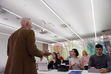 Image showing teacher with a group of students in classroom