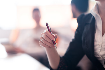 Image showing woman hands holding pen on business meeting