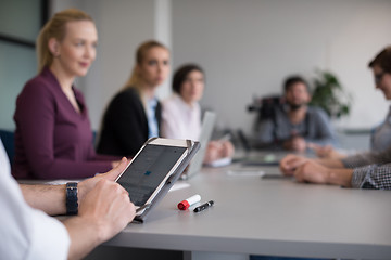 Image showing close up of  businessman hands  using tablet on meeting