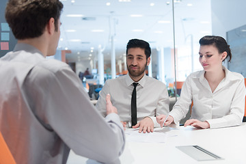 Image showing young couple signing contract documents on partners back