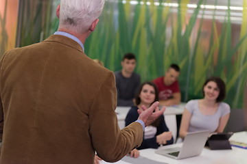 Image showing teacher with a group of students in classroom